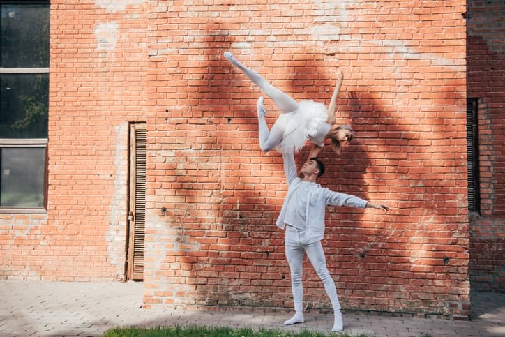beautiful-young-couple-of-dancers-performing-ballet-dance-on-city-street